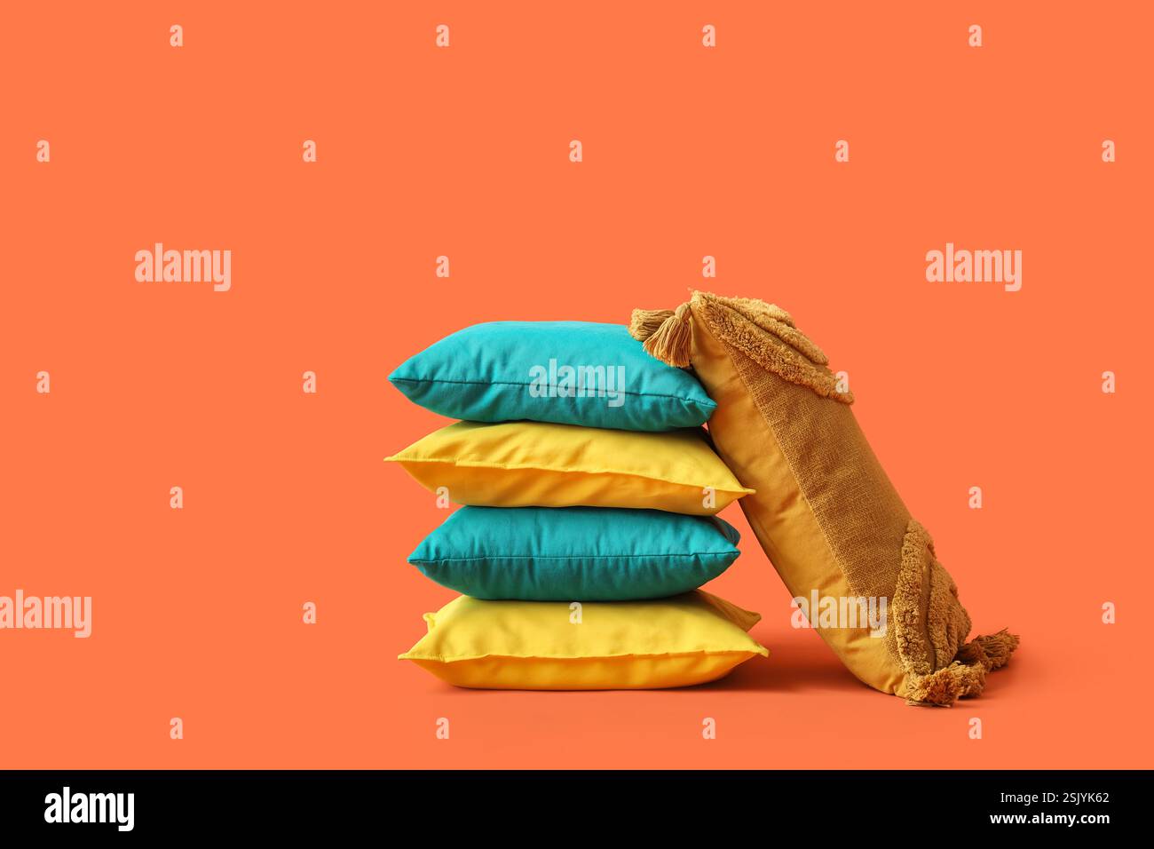 Decorative pillows on orange background Stock Photo