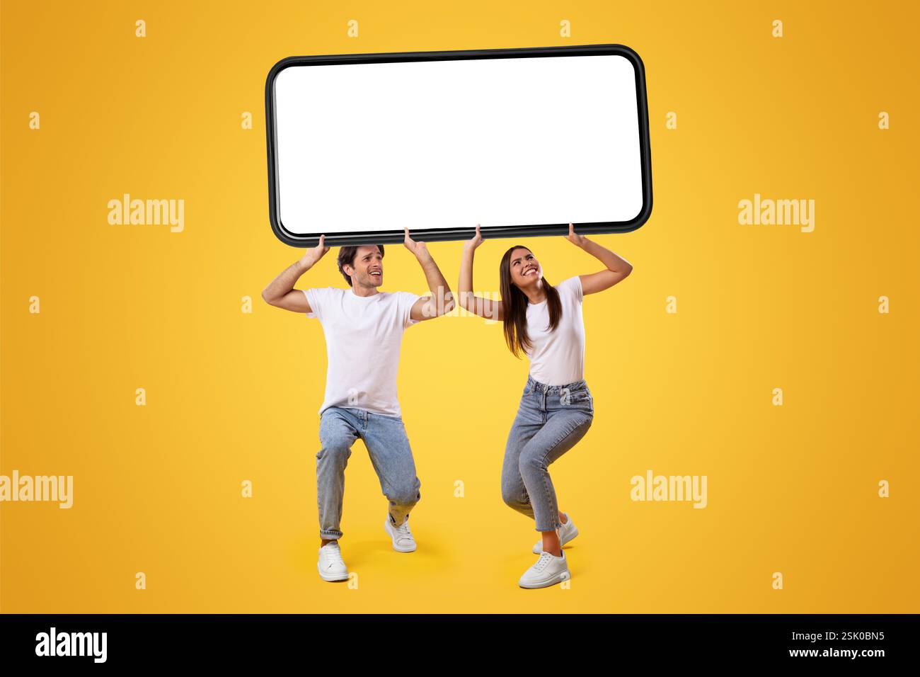 Couple holding heavy white empty smartphone screen Stock Photo