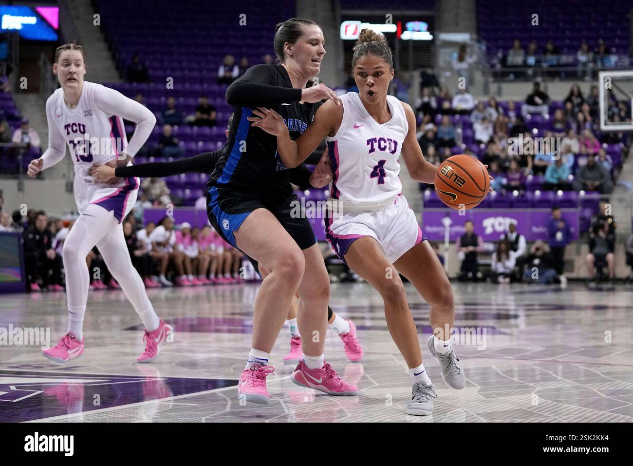 TCU guard Donovyn Hunter (4) works for a shot against BYU forward Emma ...