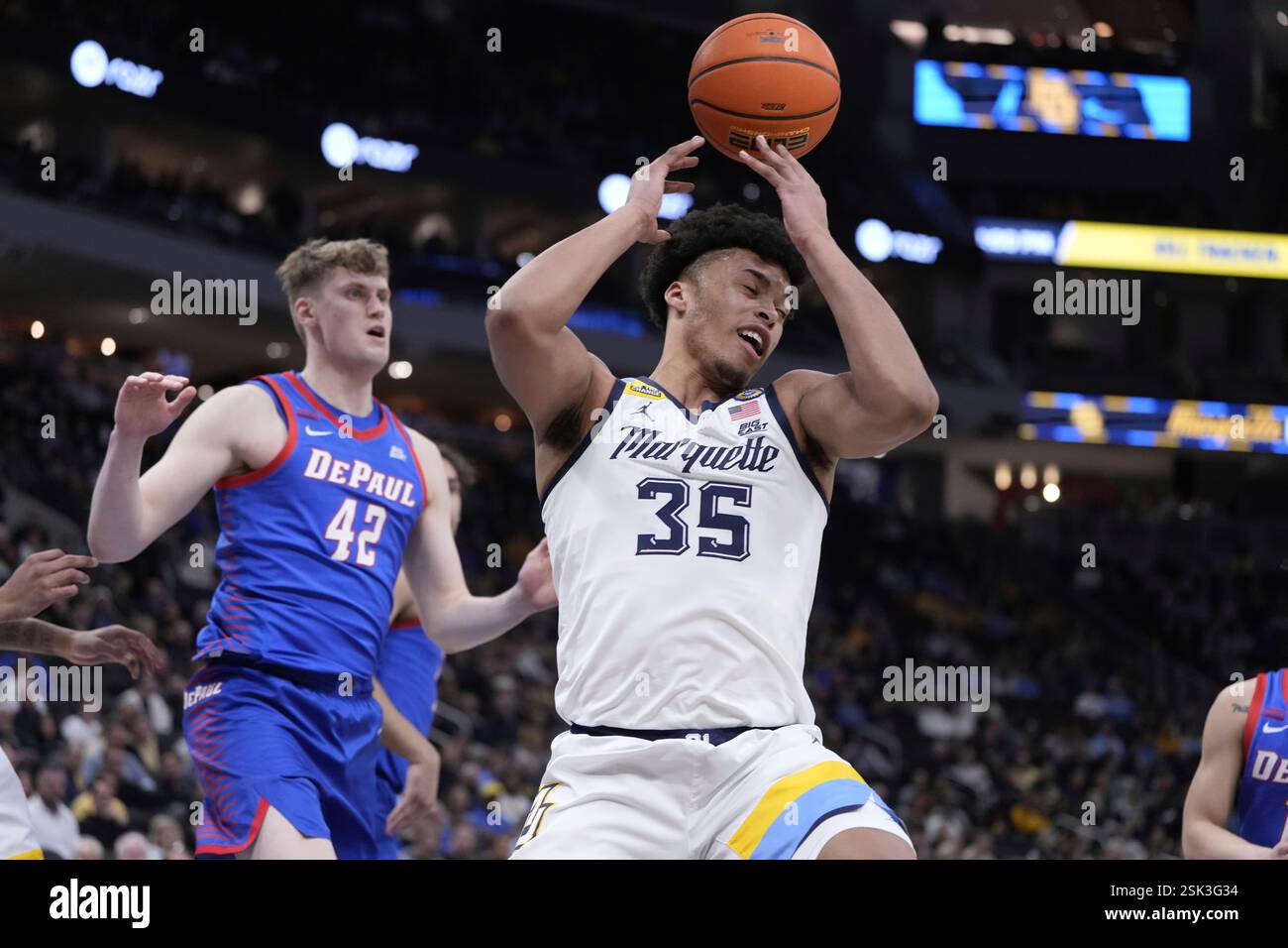 Marquette's Caedin Hamilton goes for a rebound in front of DePaul's ...