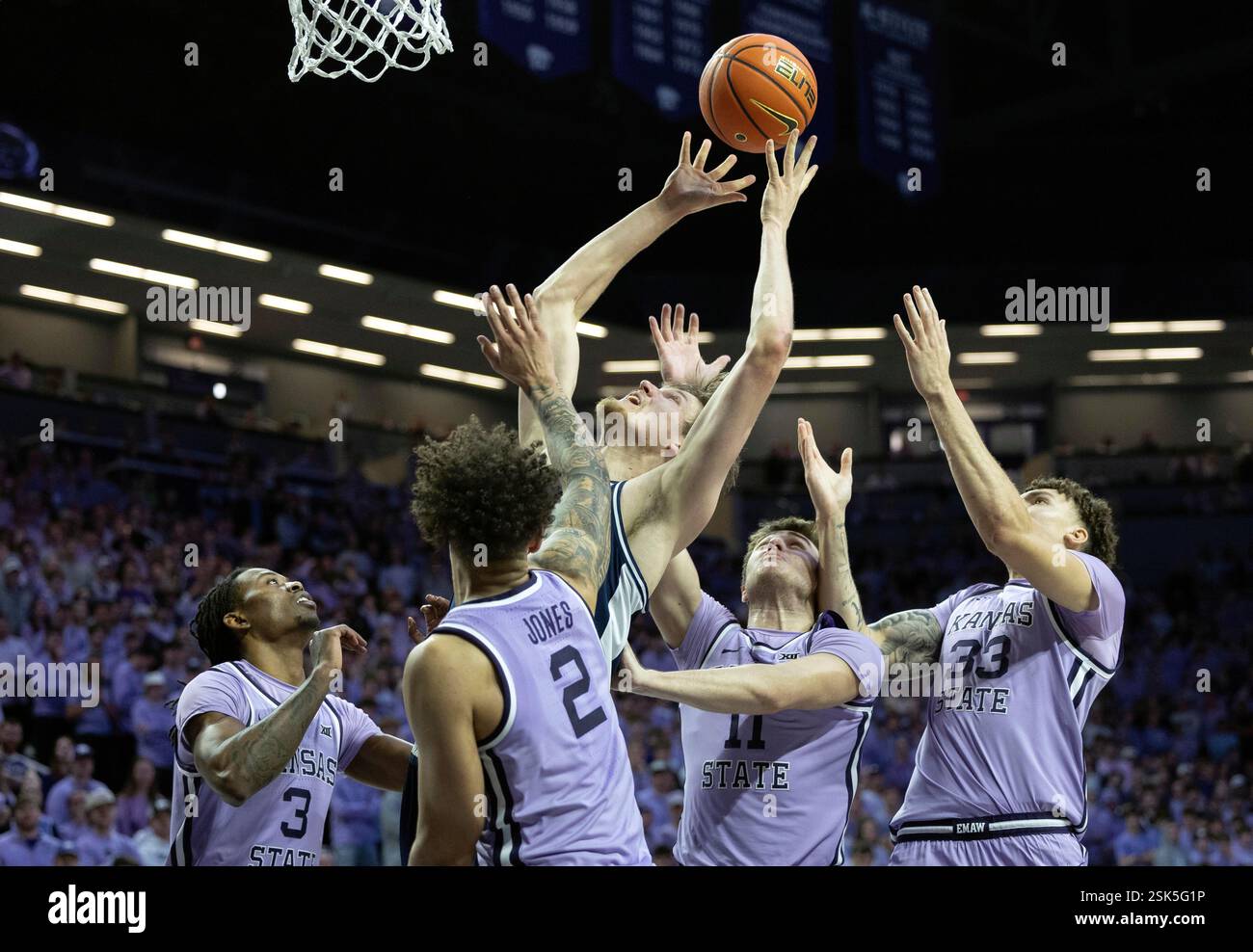 Arizona's Henri Veesaar, middle, fights for a rebound against a group