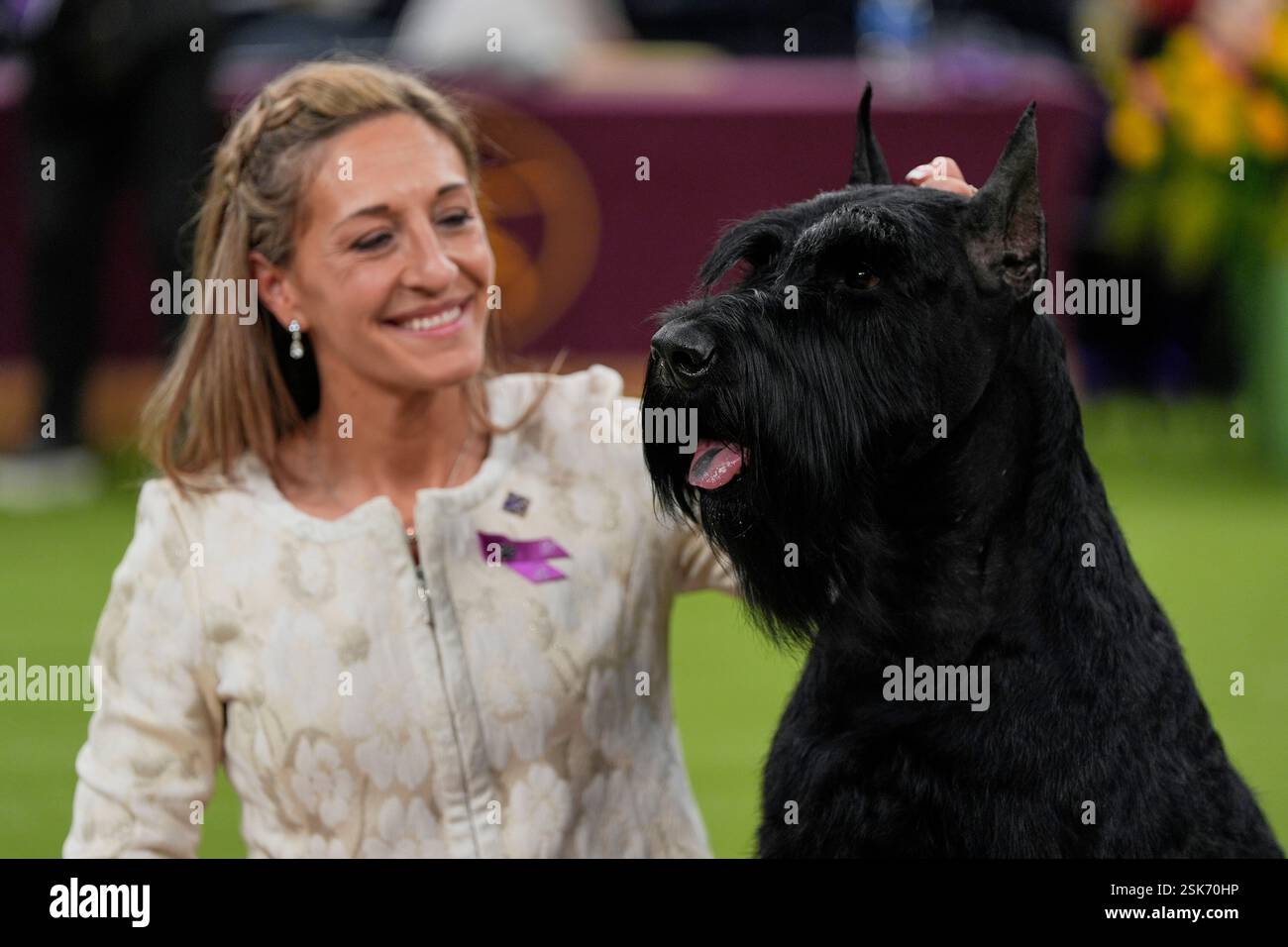 Katie Bernardin and Monty, a Giant Schnauzer, celebrate after winning best in show in the 149th