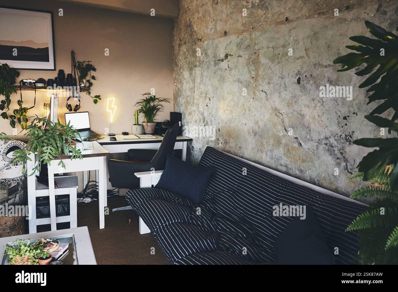 Image showcasing Sofa, home office and laptop on table for interior design, remote work ...