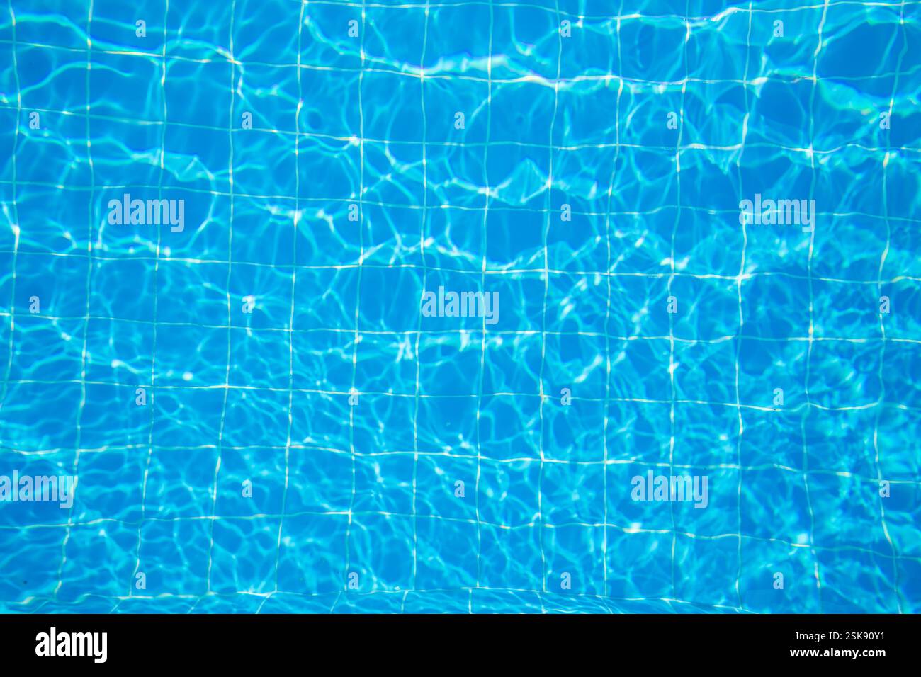 Clear blue water surface with captivating reflections in a swimming ...