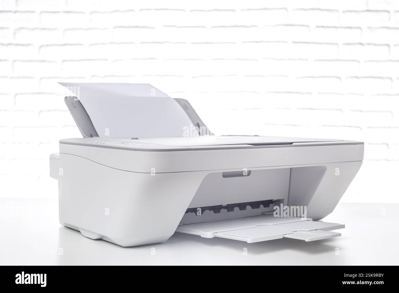 Modern multifunction printer on a clean white background ready for scanning, copying, and printing documents seamlessly Stock Photo