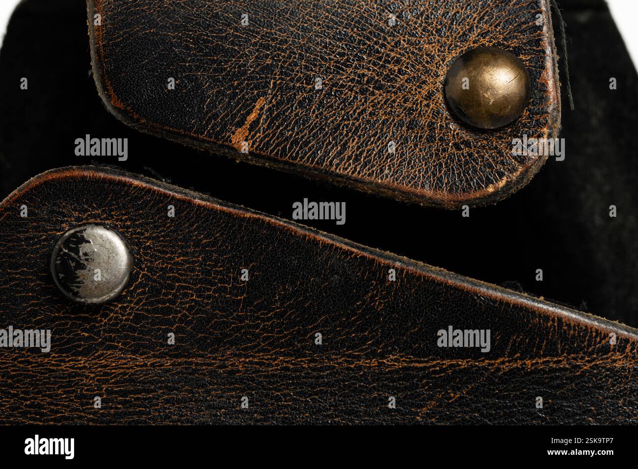 Closeup brown leather case with rivets on white background Stock Photo