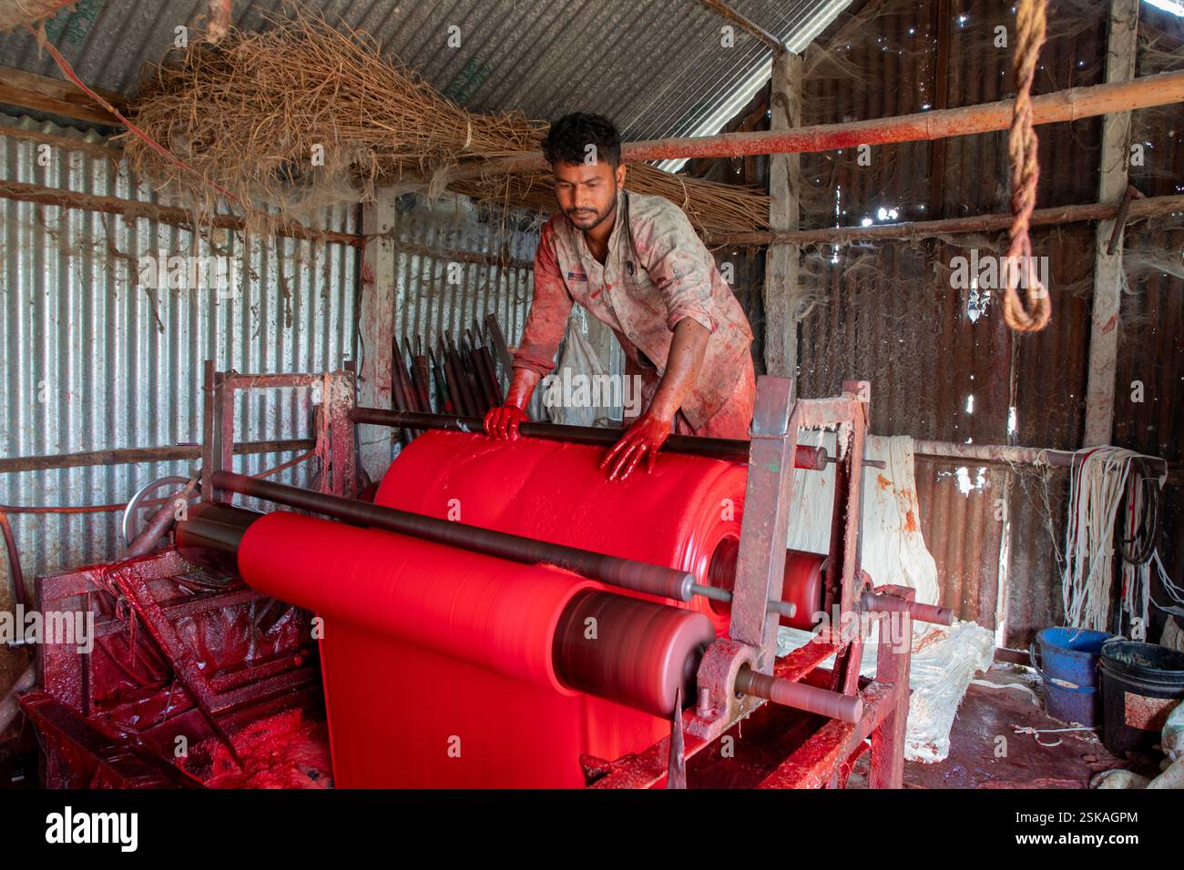 Cloth is dyed at a factory in Narsingdi, where workers handle dyes mixed with hazardous chemicals without any protective equipment. Narsingdi, Banglad Stock Photo