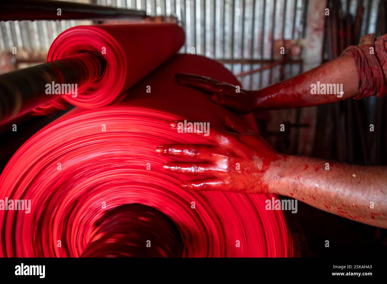 Cloth is dyed at a factory in Narsingdi, where workers handle dyes mixed with hazardous chemicals without any protective equipment. Narsingdi, Banglad Stock Photo