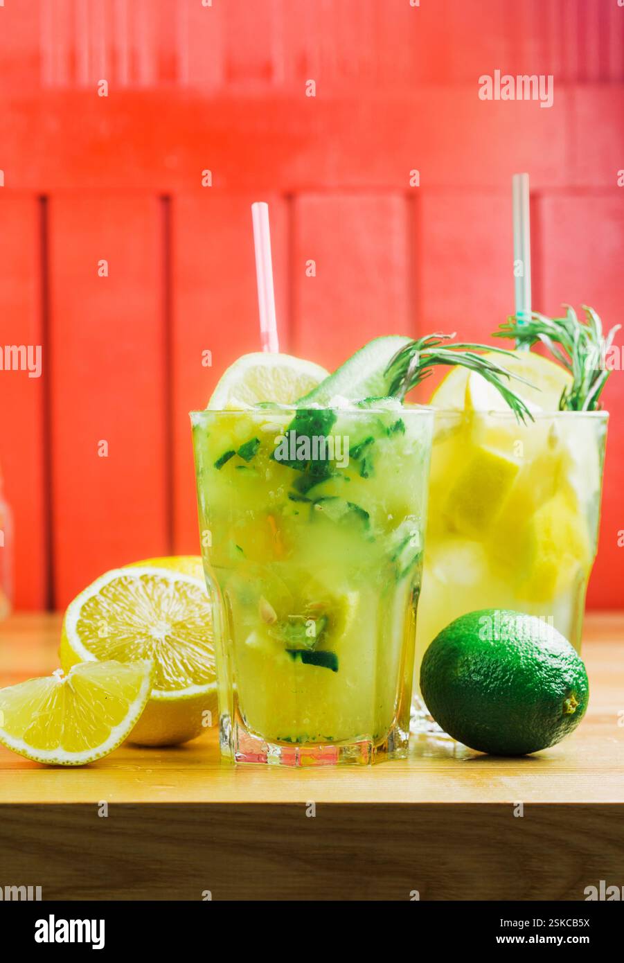 Refreshing cocktails highlight vibrant flavors of citrus and herbs in a cozy bar setting Stock Photo