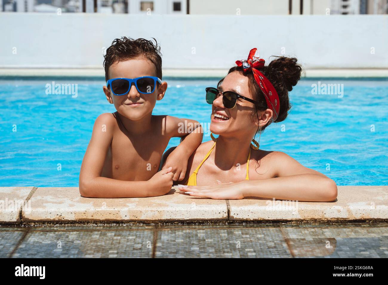 Happy Mom and son in sunglasses in the pool Stock Photo - Alamy
