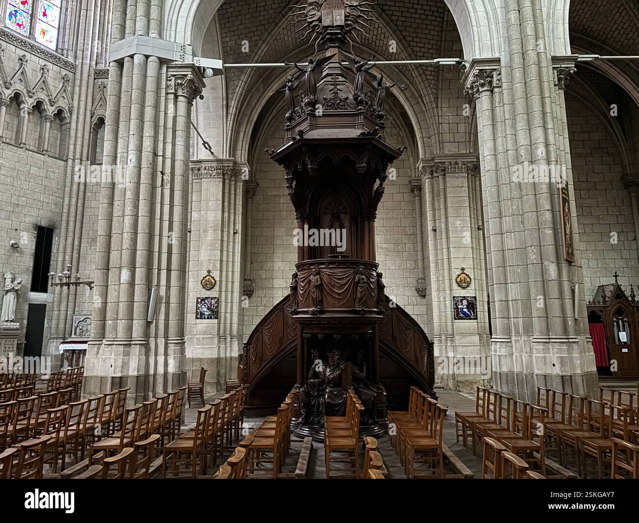 Grand Cathedral Interior showing stone vaulted ceiling and religious decoration, Stained glass windows. High walls and grand decoration. Nantes France - Smartphone Captured Stock Image