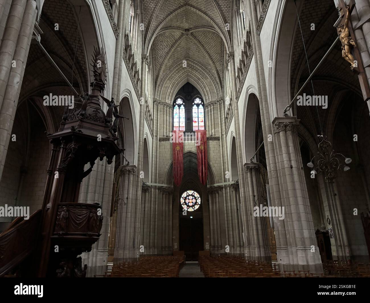Grand Cathedral Interior showing stone vaulted ceiling and religious decoration, Stained glass windows. High walls and grand decoration. Nantes France - Smartphone Captured Stock Image