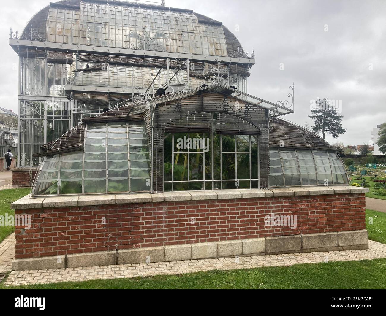 Old greenhouses with beautiful metal arches and glass panes in a public park in the centre of Nantes, France. Famous tourist destination sight. - Smartphone Captured Stock Image