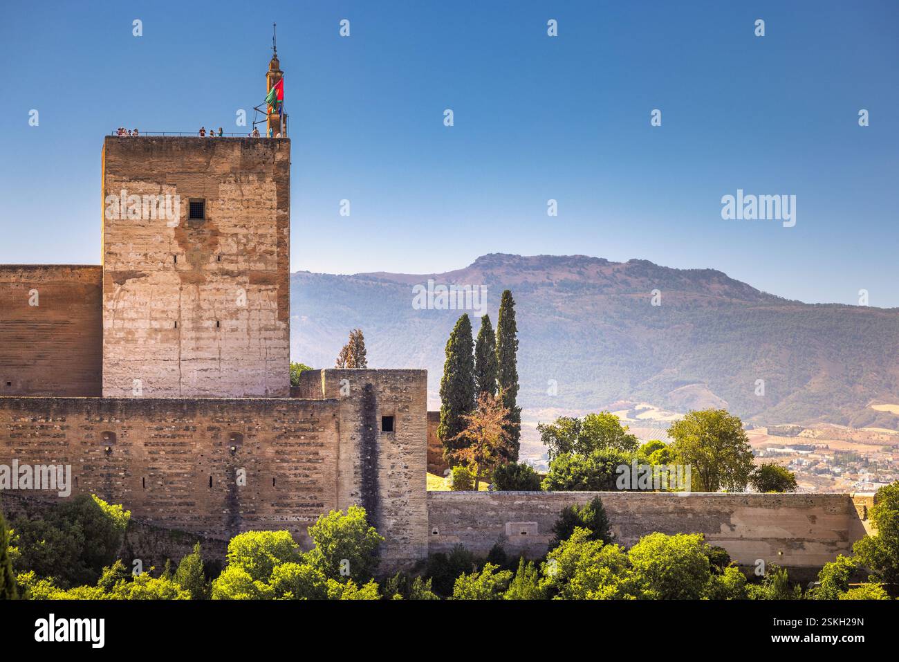 An imposing stone structure stands tall against a clear blue sky ...