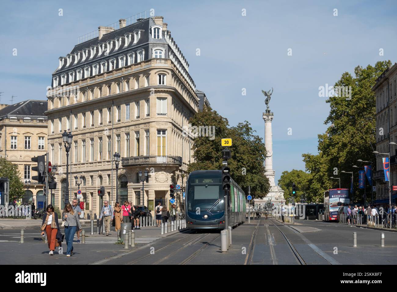 Tram along Cr du 30 Juillet with Monument aux Girondins in distance, Bordeaux, Nouvelle-Aquitaine, France, Europe Stock Photo