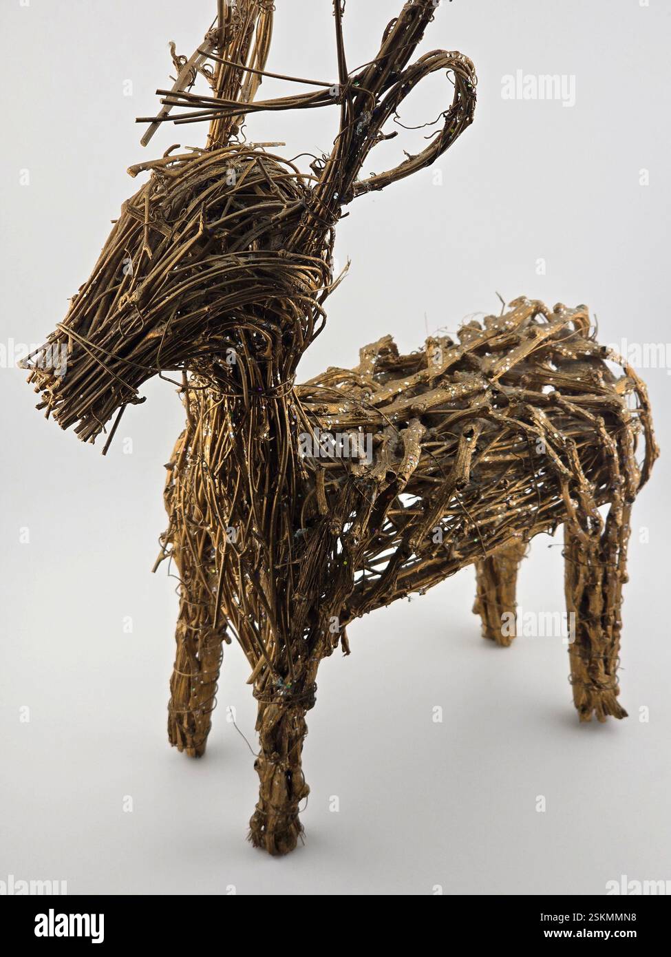 Deer made of branches with antlers on a white background. An interesting animal figure made of natural materials. - Smartphone Captured Stock Image
