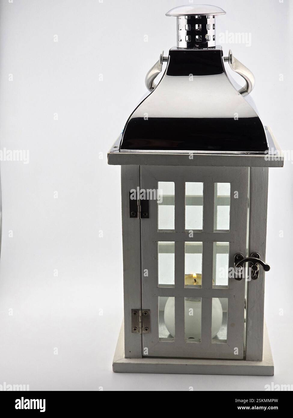 A white lantern, lamp with a candle burning inside. - Smartphone Captured Stock Image