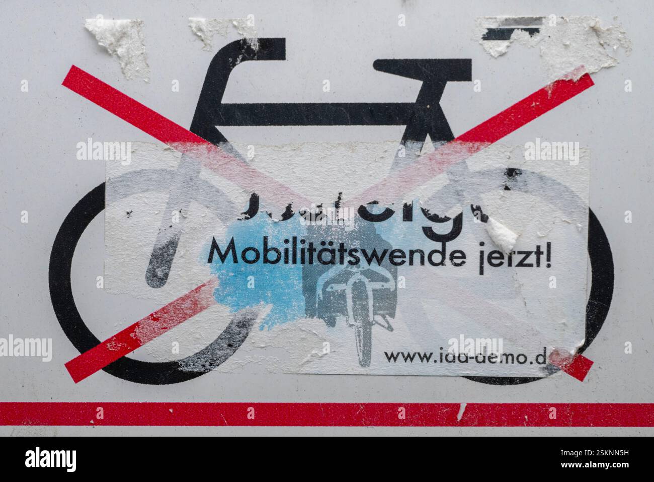 Munich, Germany. 12th Feb, 2025. The pictogram 'No bicycle parking' is covered with a sticker reading 'Mobility turnaround now!' in the Haidhausen district. Credit: Peter Kneffel/dpa/Alamy Live News Stock Photo