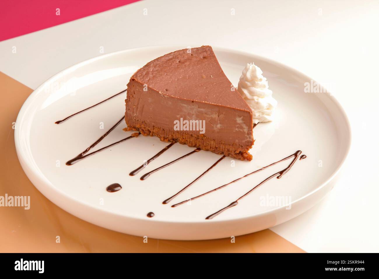 Chocolate cheese cake served with cream. Stock Photo
