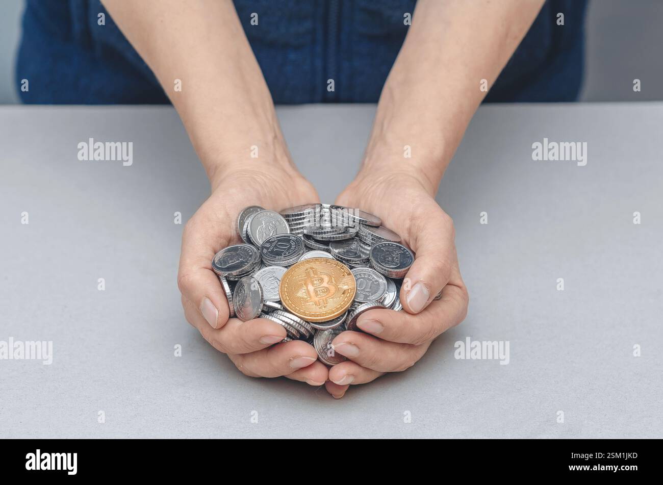 Golden Bitcoin in palms with coins. Risks, stock market fluctuations and  Bitcoin cryptocurrency Stock Photo - Alamy