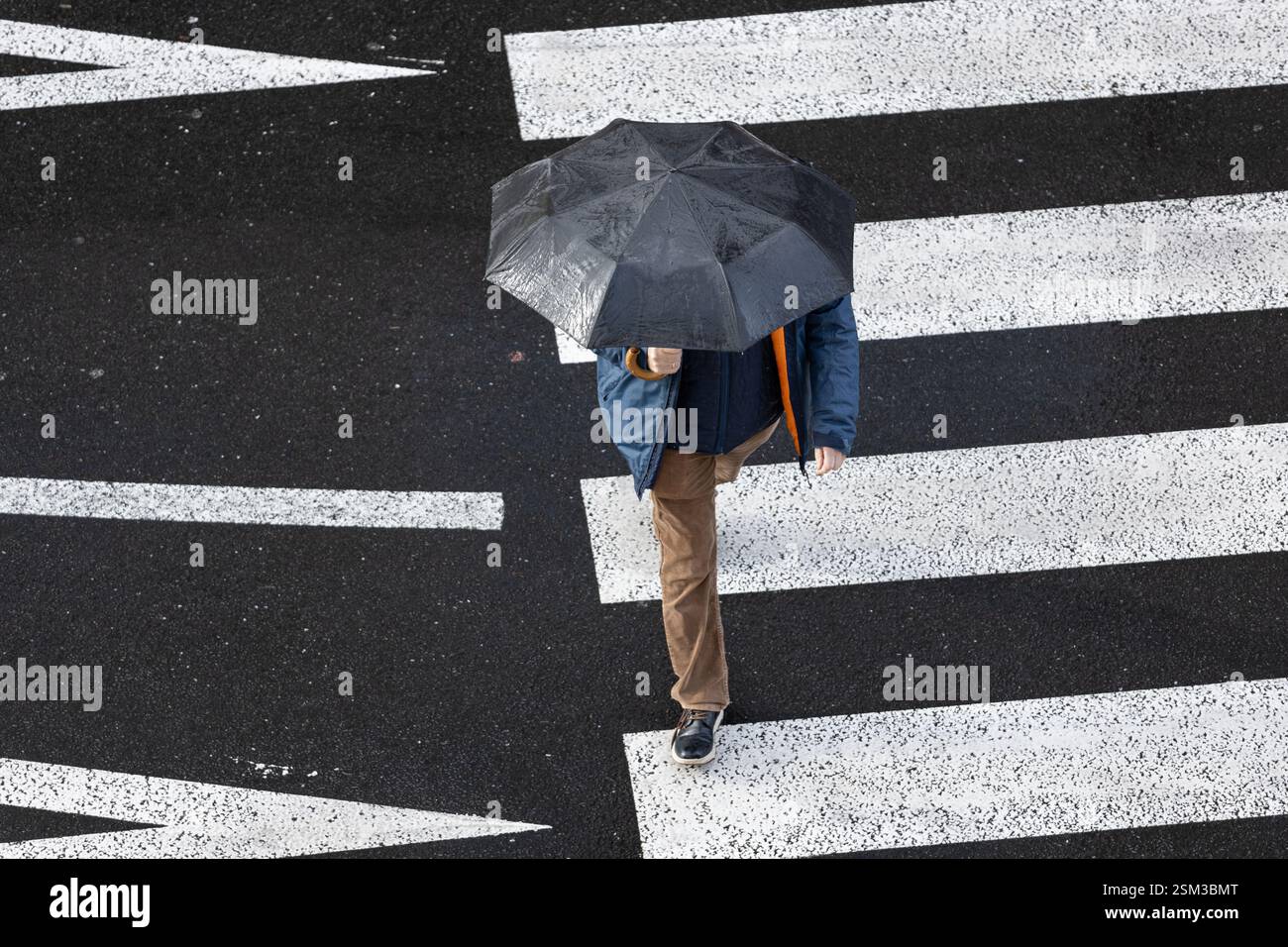 Pedestrian crossing crosswalk on rainy day in the city using an ...