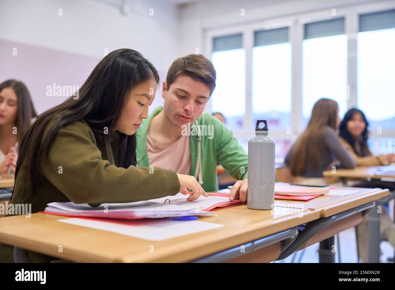 Institute students collaborating on project in classroom environment Stock Photo