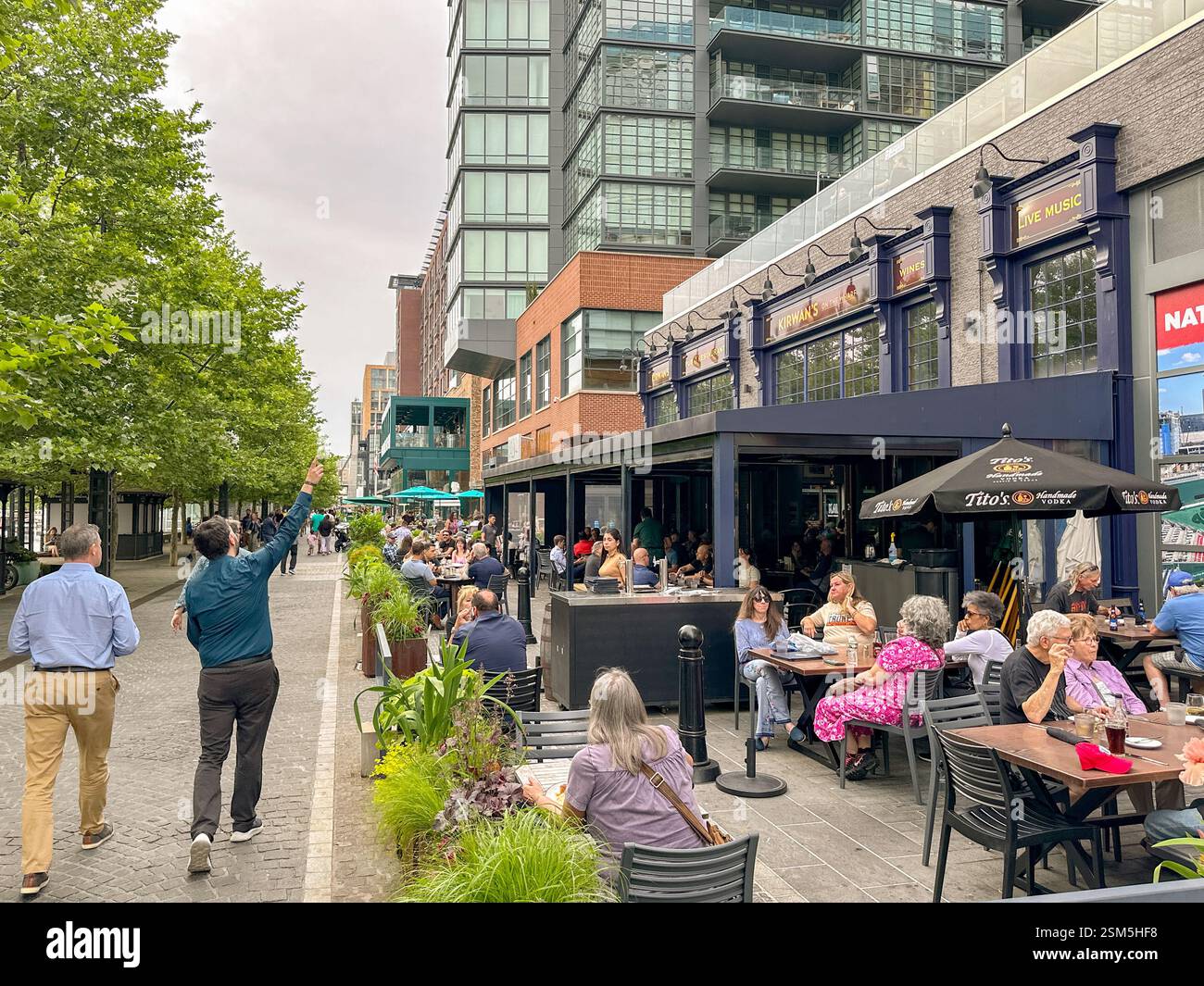 Washington DC, USA - 3 May 2024: People at an outdoor restaurant and bar on the Wharf development of restaurants, bars and hotels - Smartphone Captured Stock Image