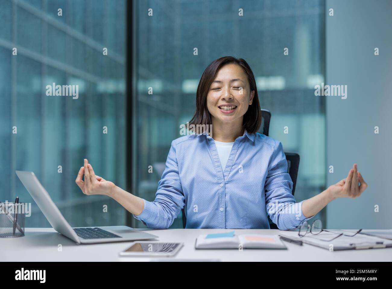 Young joyful Asian woman meditating, resting and relaxing in lotus ...