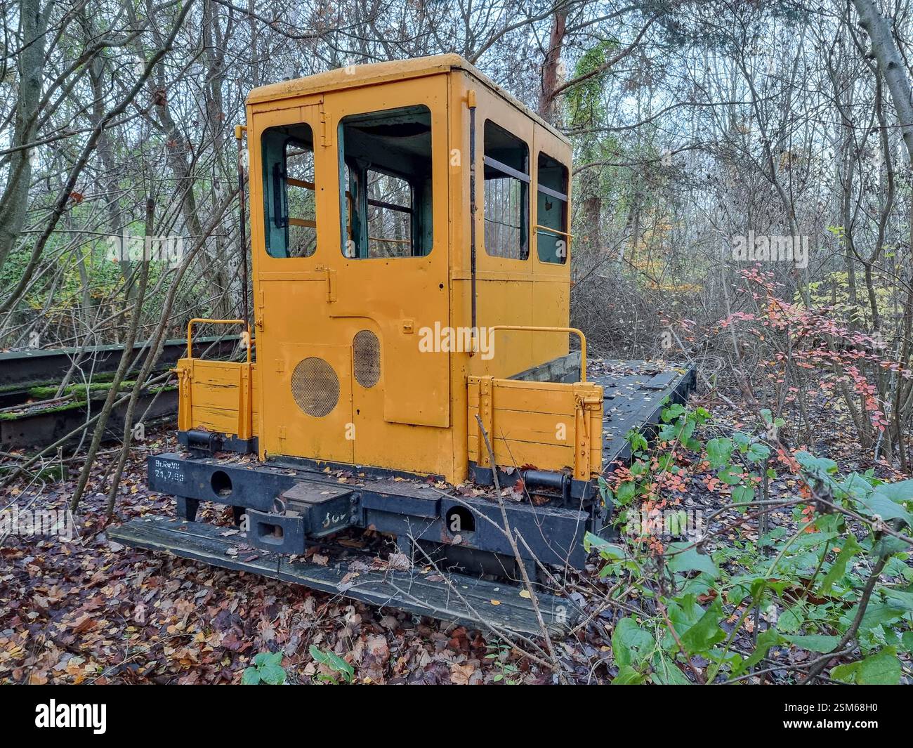 Historic yellow shunting locomotive in Nature Park Schöneberger Südgelände on the former Tempelhof railway yard in Berlin, Germany - Smartphone Captured Stock Image