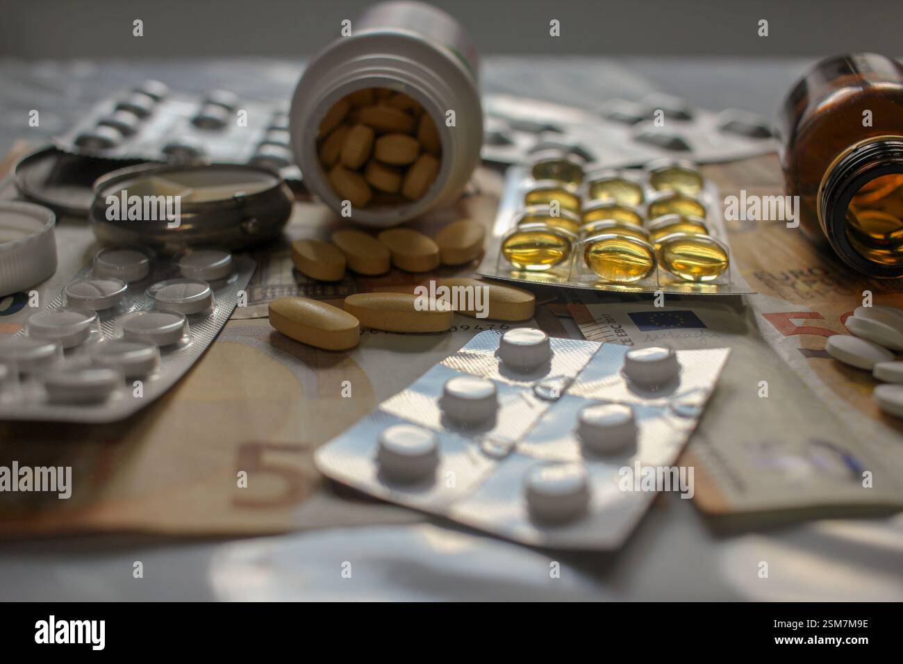 several pills and bank notes on the table Stock Photo