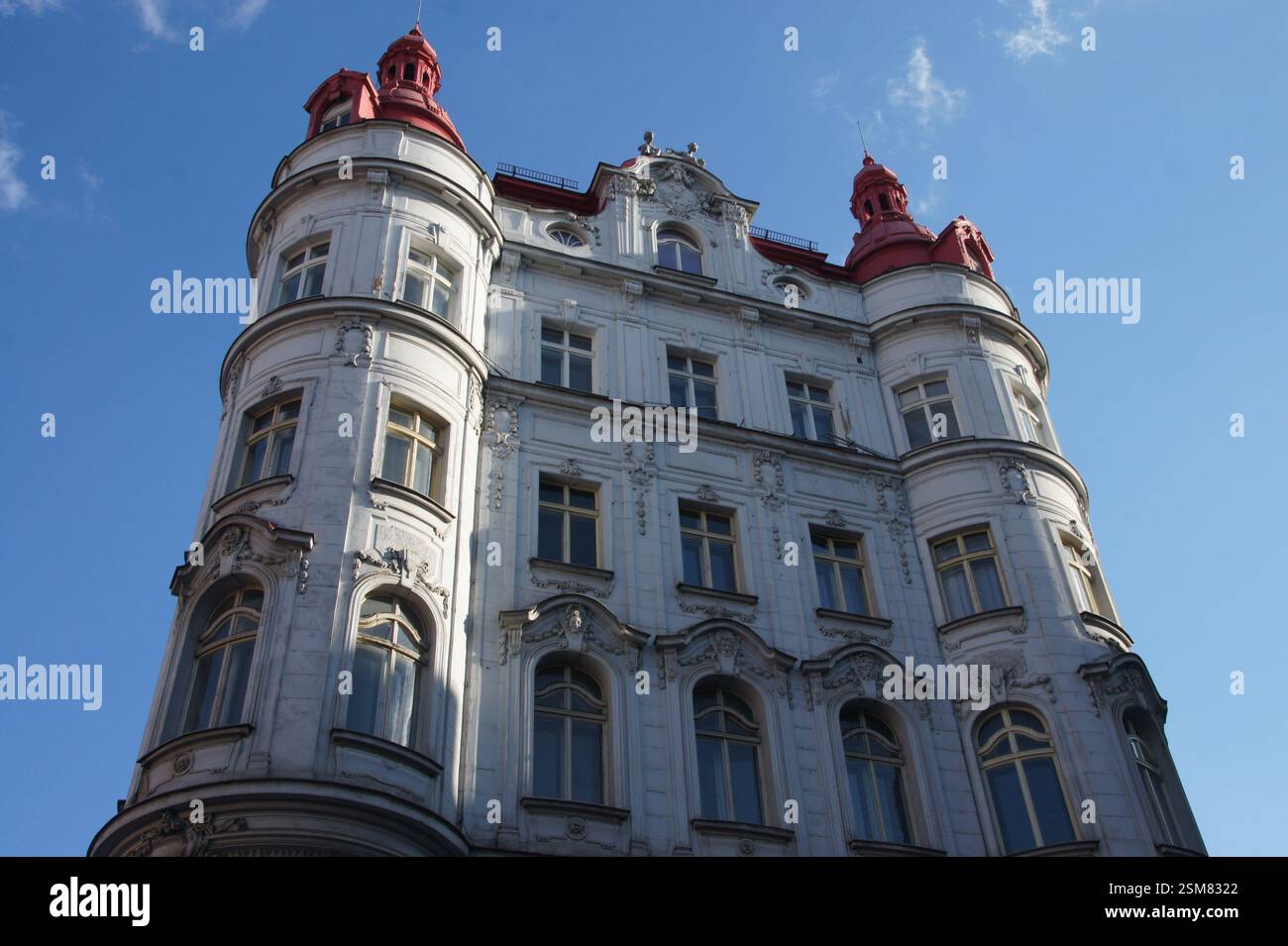 Building white facade ornate detailing red roof. Architectural style ...