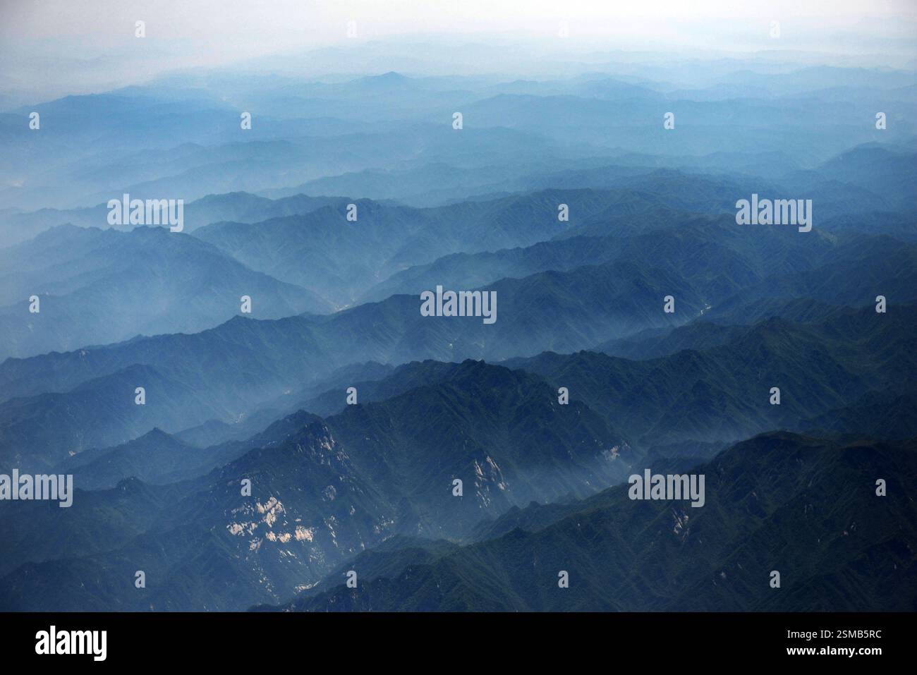 Aerial View of Endless Mountain Ranges Covered by Soft Hazy Layers ...