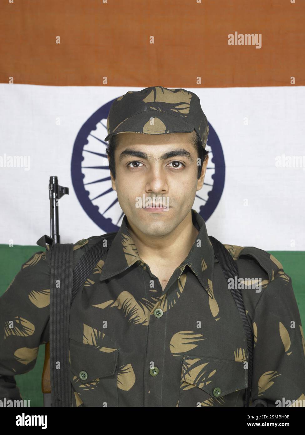 Indian Army Soldier With AK 47 Gun In Front Of Flag Of India In Indian Army Soldier With AK 47 Gun In Front Of Flag Of India In