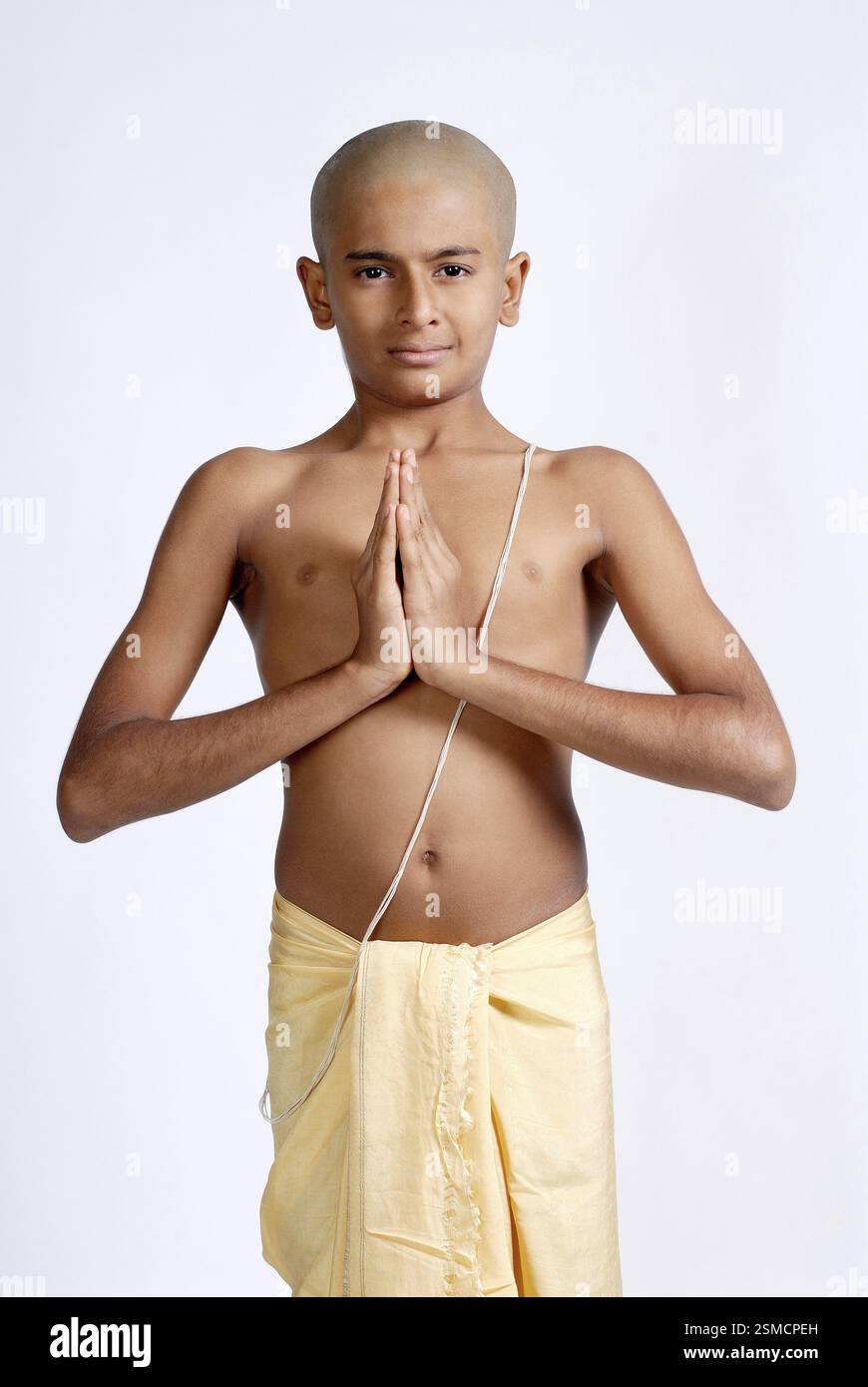 South Asian Indian bald boy in dhoti wearing sacred thread doing ...
