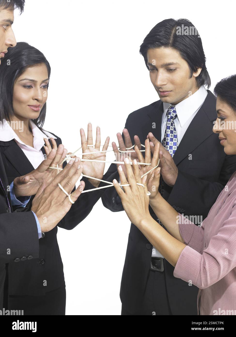 South Asian Indian executive men and women doing the cat's cradle with ...