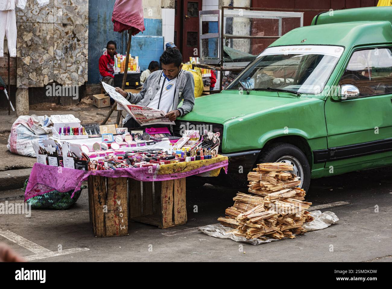 Man reading newspaper, stall at Analakely Market Antanarivo, Madagascar, Africa Stock Photo