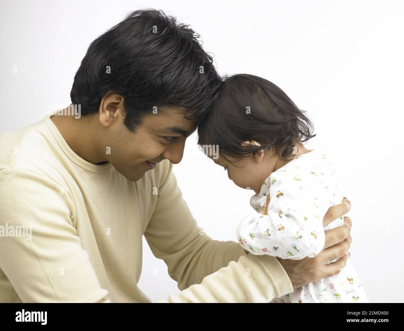 Indian father and baby girl touching forehead MR#702O, 702A Stock Photo ...