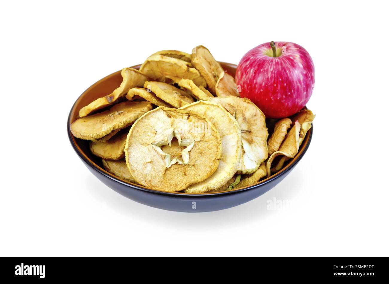 Fresh red apple and dried apple slices in a bowl isolated on white background Stock Photo