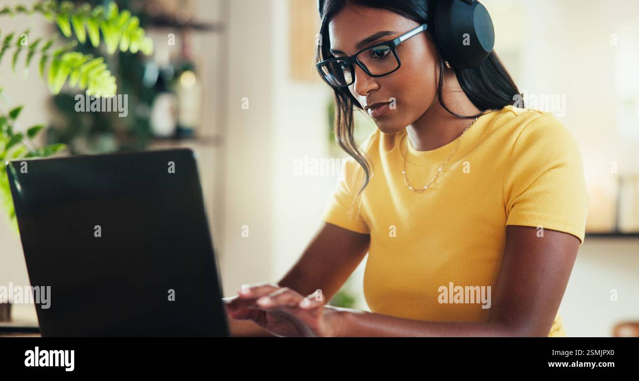 Laptop, music and typing with Indian woman in home office as graphic ...