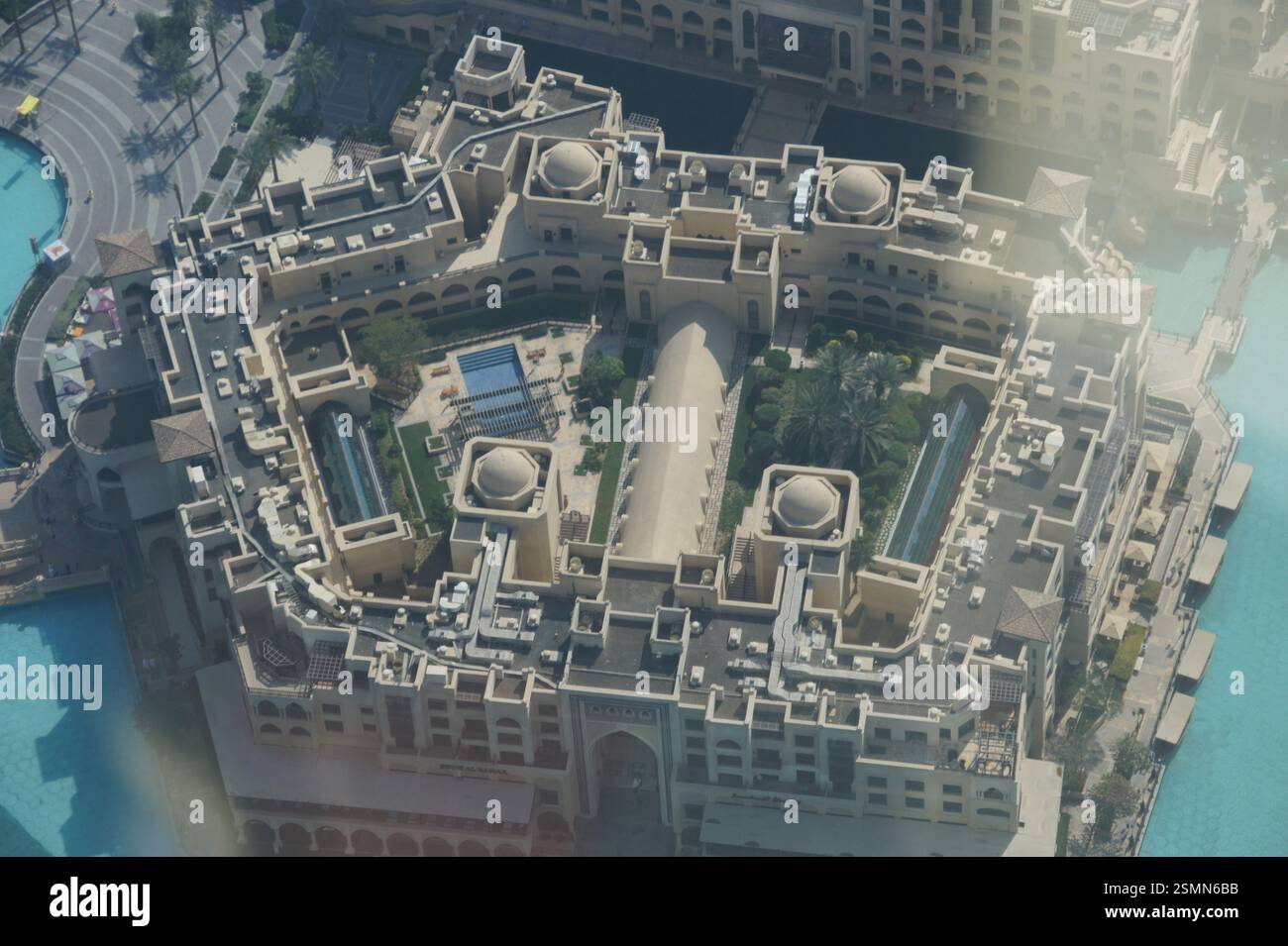 Aerial view of Dubai reveals a high-rise building crowned with a ...