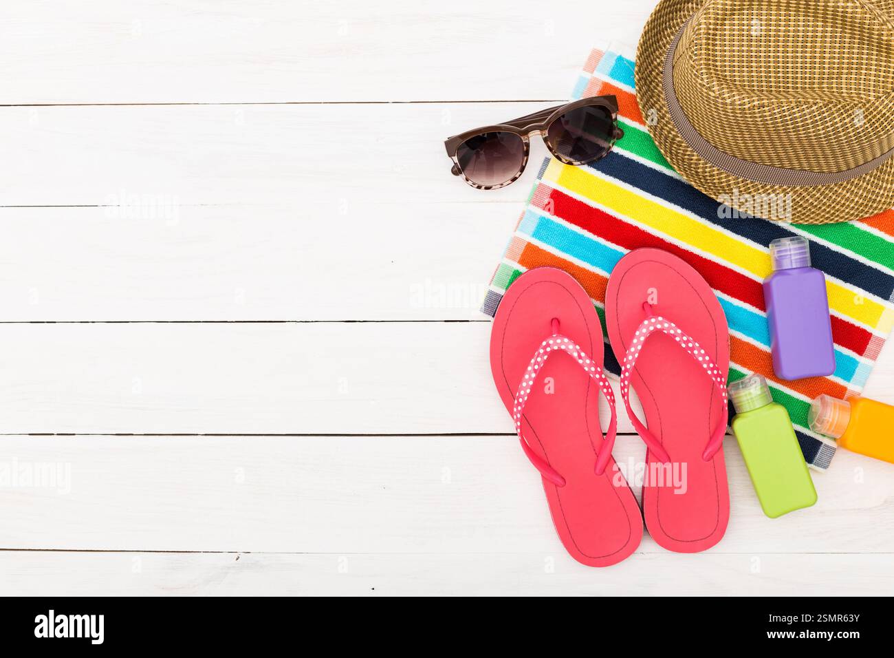 Summer relaxation essentials at the beach with vibrant flip flops, a ...