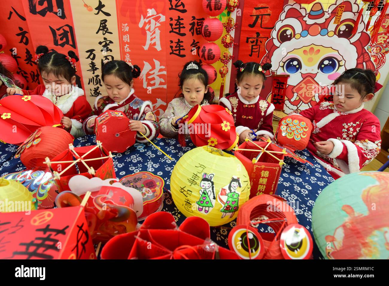 Children learn to make lanterns to welcome the Lantern Festival in ...