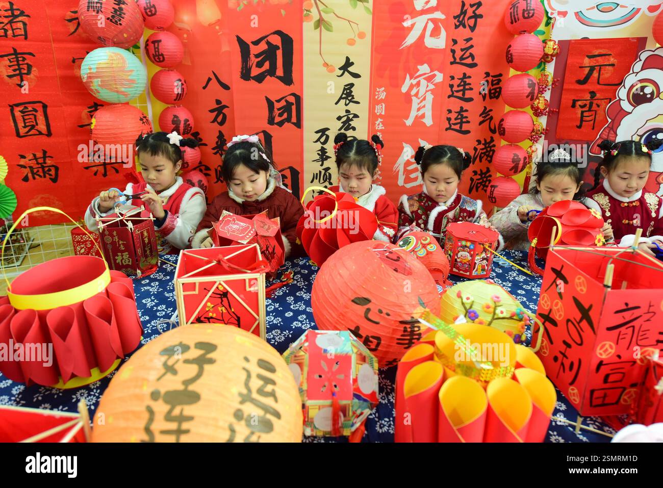 Children learn to make lanterns to welcome the Lantern Festival in ...