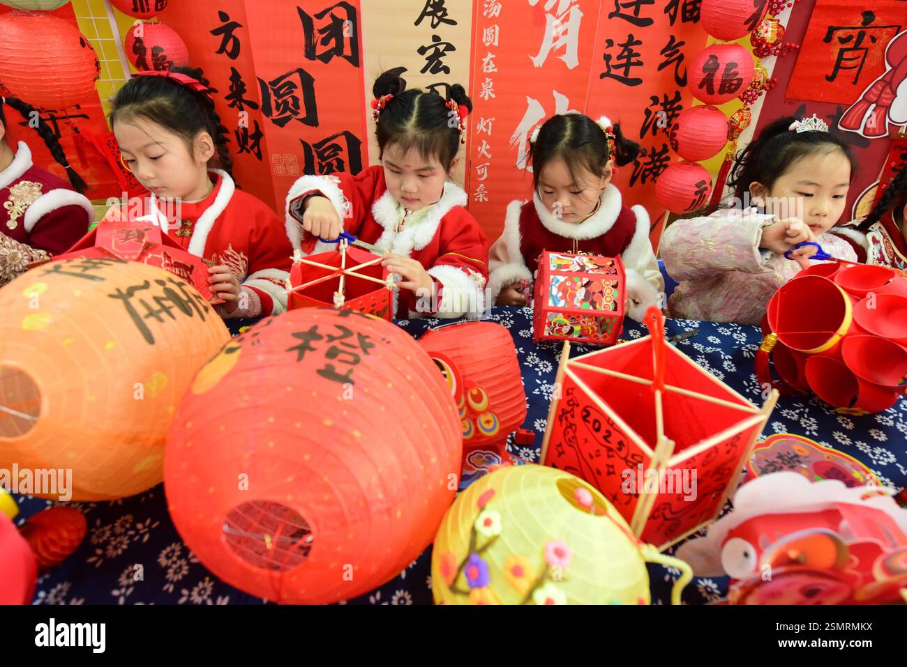 Children learn to make lanterns to welcome the Lantern Festival in ...