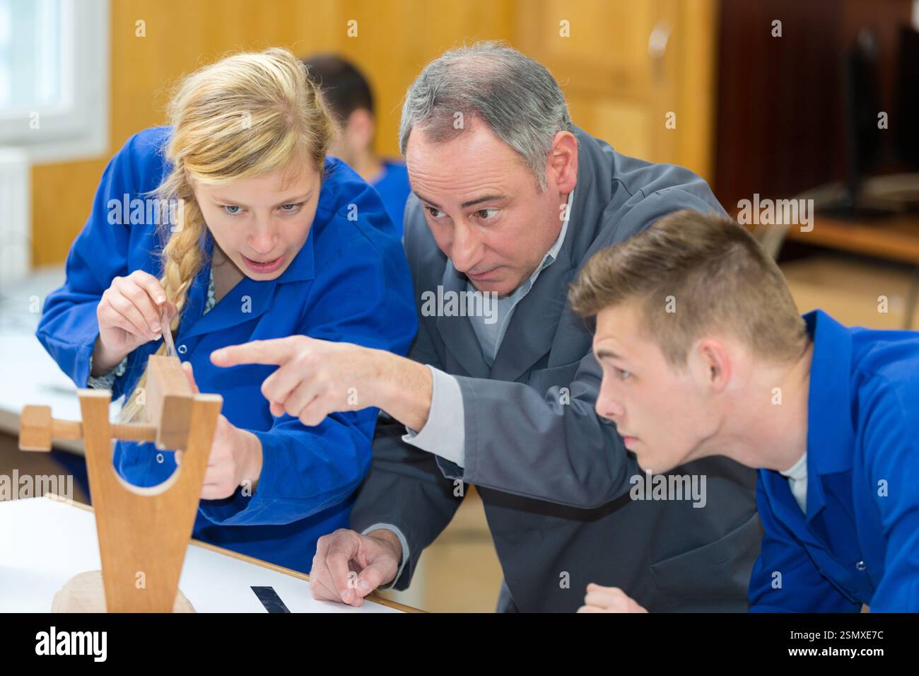 carpenter with students in woodworking workshop Stock Photo