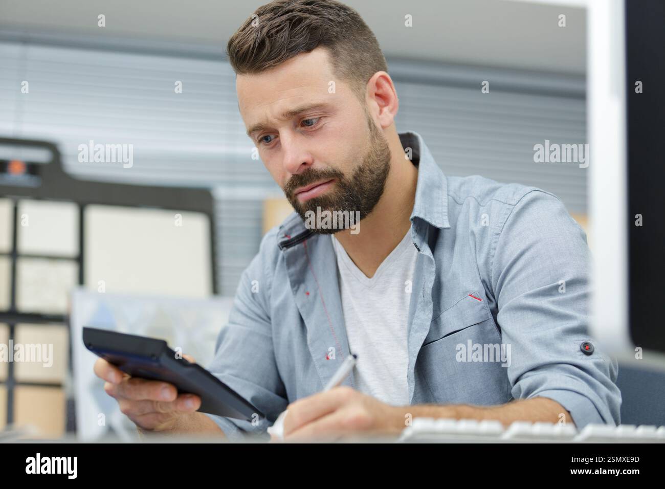 Manager Using Calculator warehouse manager using his calculator Stock Photo - Alamy