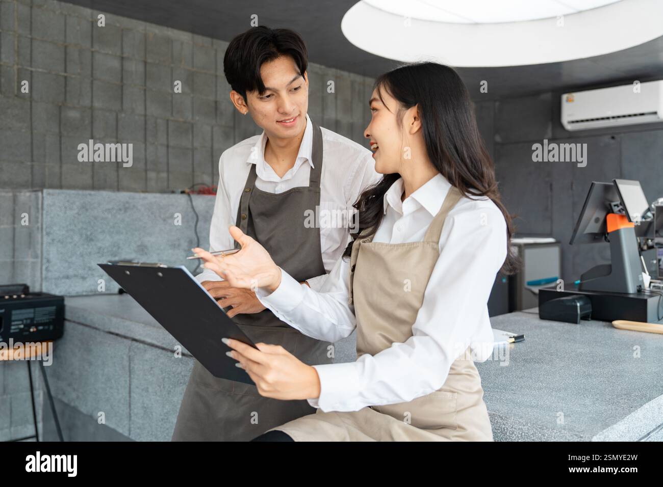 Cafe staff discussing new menu ideas with enthusiasm in a modern ...