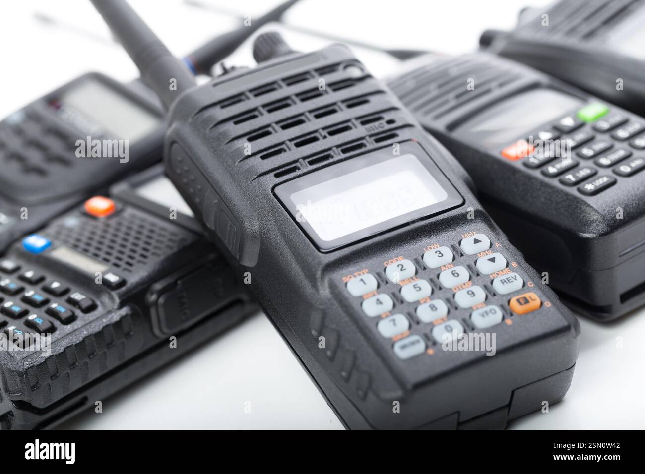 Various handheld radios in close-up with a focus on communication ...
