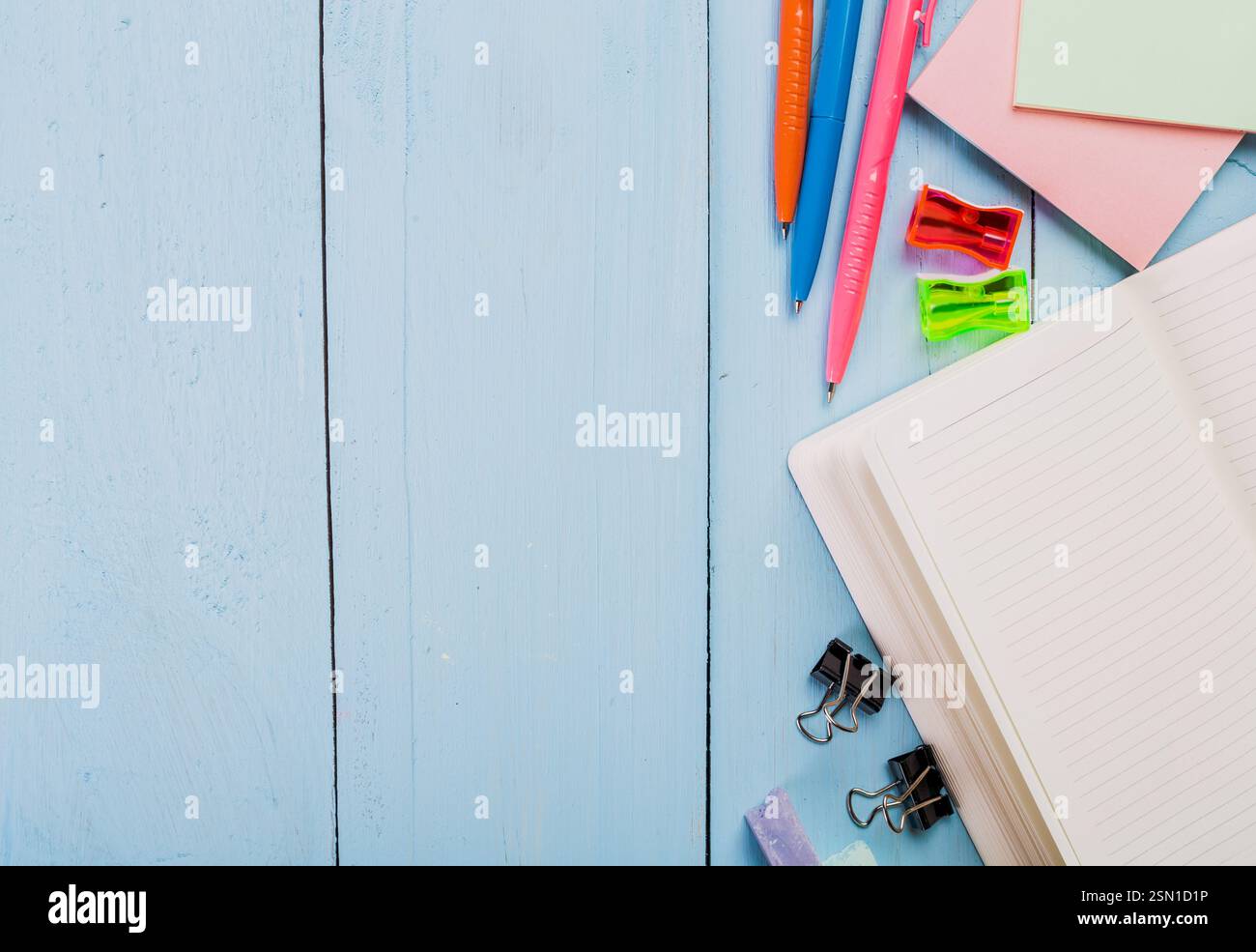 Desk setup with stationery, colorful pens, and notes organized on a ...