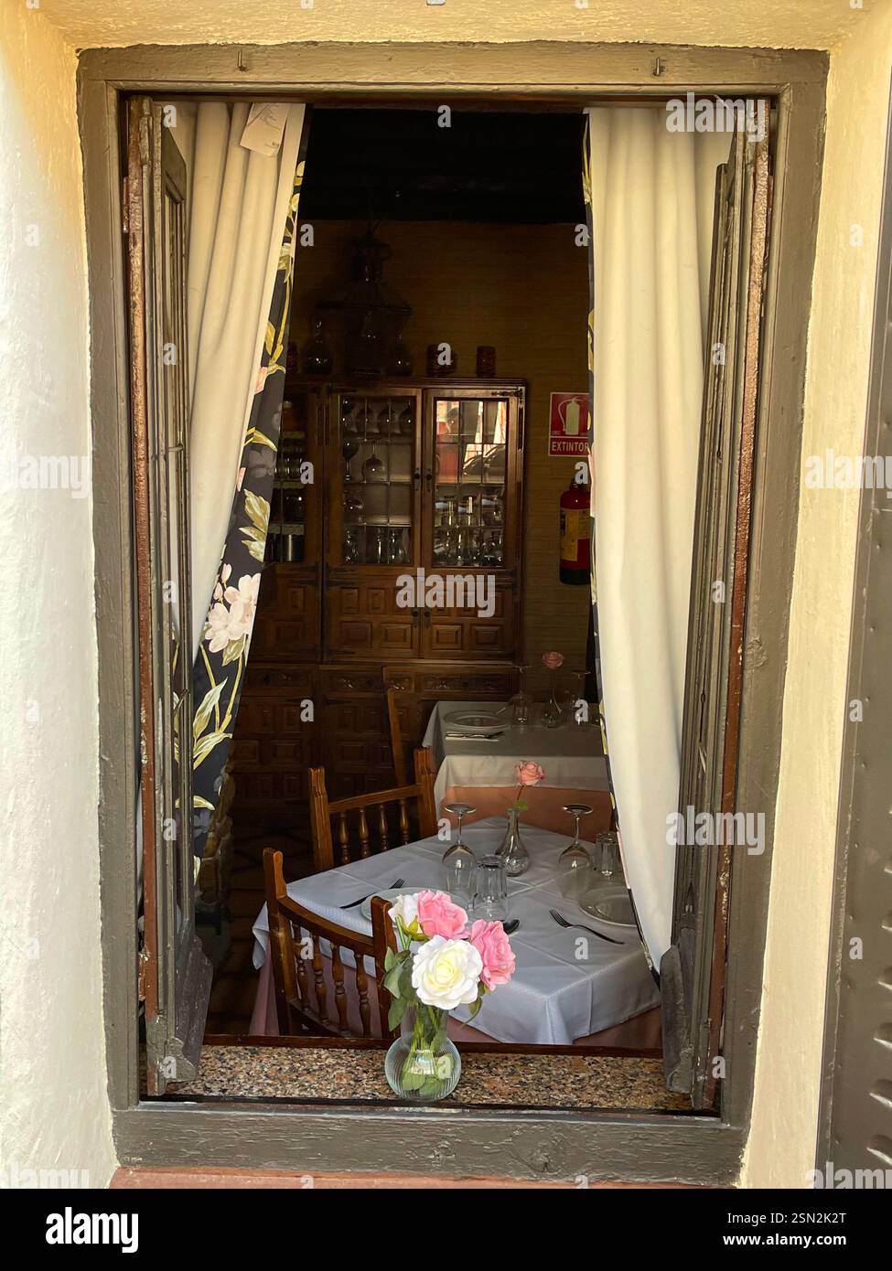 Interior of restaurant viewed through an open window. Rascafria, Madrid province, Spain. - Smartphone Captured Stock Image
